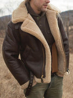 Brown leather jacket with tan shearling trim and stand collar; zip and pockets