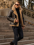 Brown leather jacket with tan shearling collar and cuffs; front zip closure