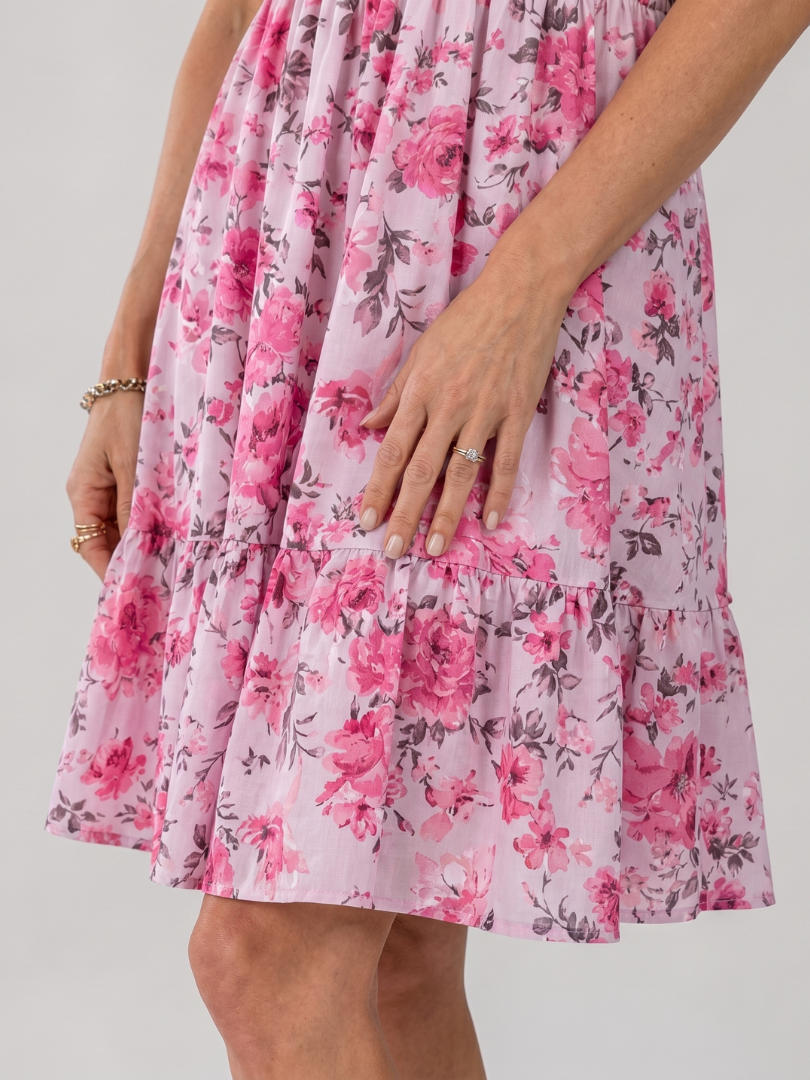 Pink floral tiered knee-length dress close-up, gathered waist and ruffle layers