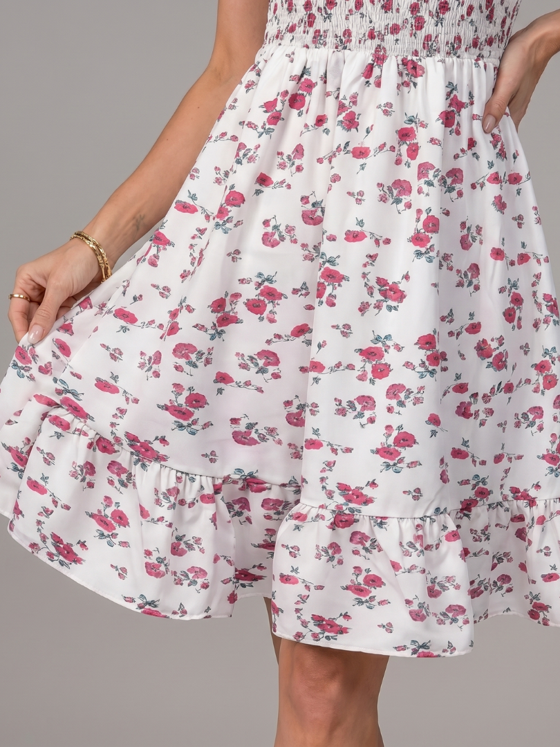 White-and-pink floral dress close-up, tiered ruffle hem and gathered waist