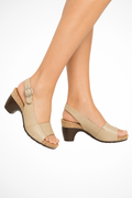 Beige block-heel slingback sandal with open toe, circular buckle strap, textured sole.
