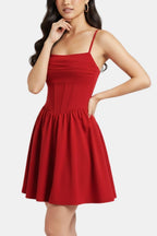 Red ruched mini dress with spaghetti straps and flared skirt, fitted bodice and gathered waist