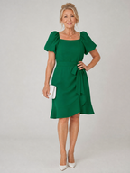 Green mini dress with puff sleeves, square neckline, and side tie detail at waist