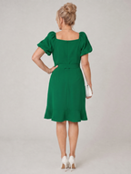 Green back view mini dress with puff sleeves and waist tie detail
