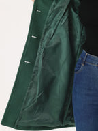 Green winter trench coat interior lining detail with buttoned sleeve placket