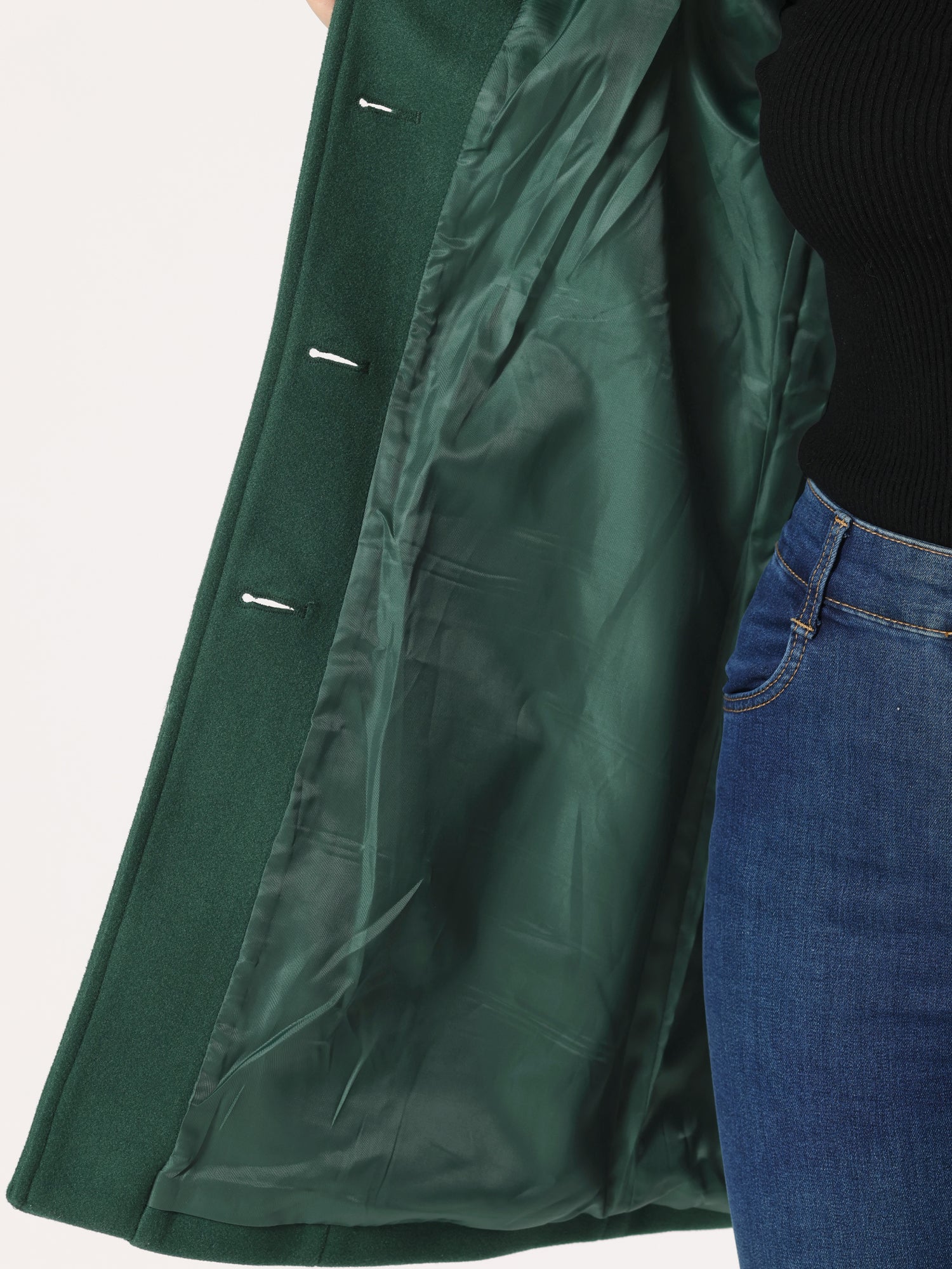 Green winter trench coat interior lining detail with buttoned sleeve placket