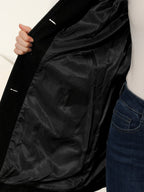 Black winter trench coat interior lining with smooth fabric and sleeve opening