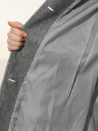 Grey winter trench coat interior lining detail near seam and sleeve opening