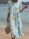 Light blue embroidered midi dress, round neck, 3/4 sleeves, gathered waist, relaxed flowy fit.