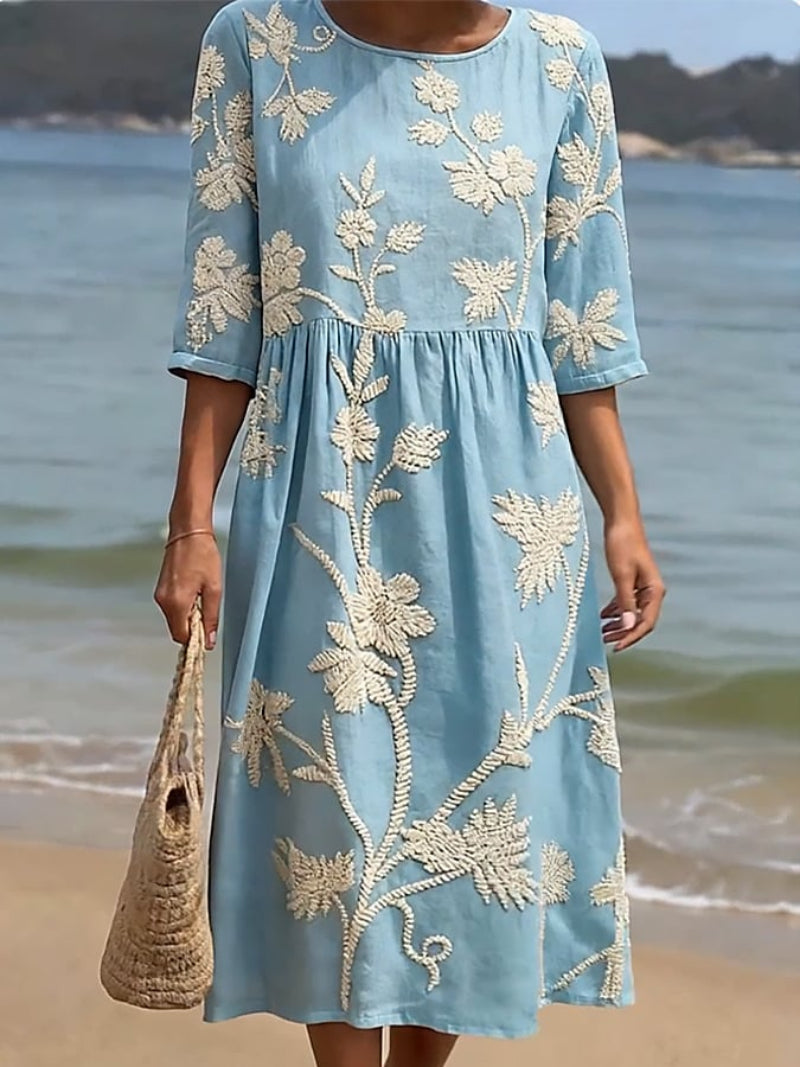 Light blue embroidered midi dress with round neck, 3/4 sleeves, gathered skirt, flowy fit.