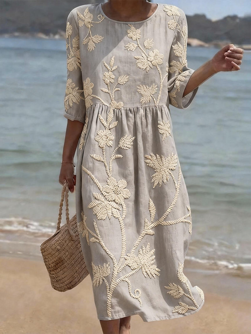 Light gray embroidered midi dress, round neck, 3/4 sleeves, gathered waist, relaxed flowy fit.