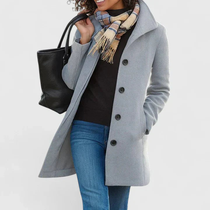 Light gray long coat with button front, notched lapels, and side pockets