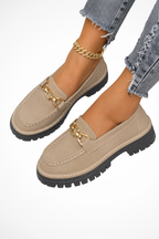 Tan women's chain detail slip-on loafers with gold-toned buckle accents and chunky sole