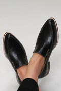 Women's black leather slip-on loafers, low-profile with minimal stitching