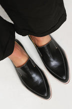 Women's black leather slip-on loafers, pointed loafer shape with stitched edges