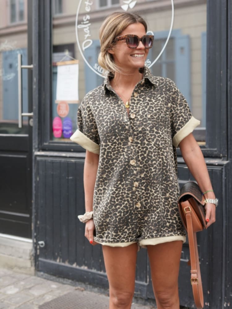 Brown leopard print romper with short sleeves, button front, and elastic drawstring hem