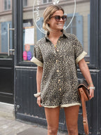 Brown leopard print romper with short sleeves, button front, and elastic drawstring hem