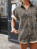 Brown leopard print romper jumpsuit detail view: short sleeves and button-up shirt front