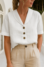 White short-sleeve blouse with shawl collar, wrap neckline, and button front