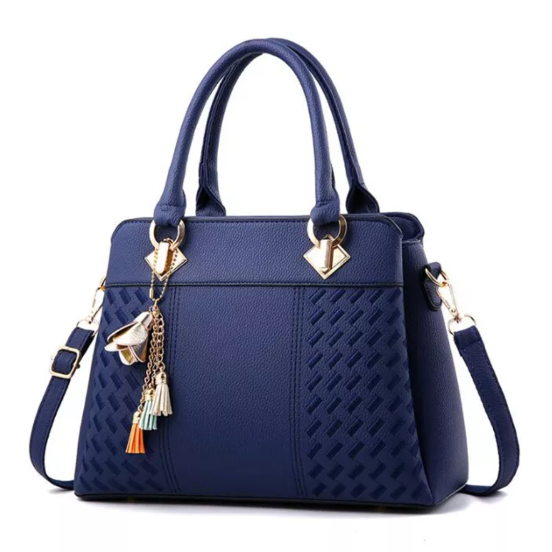 Blue textured shoulder bag with top handles, tassel charms, gold-tone hardware, strap