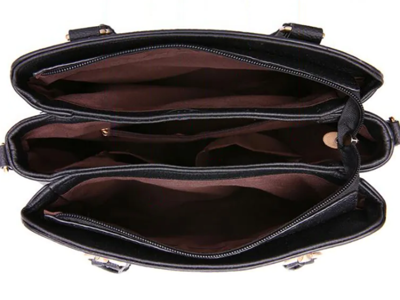 Black shoulder bag open view with zip closure and roomy interior lining