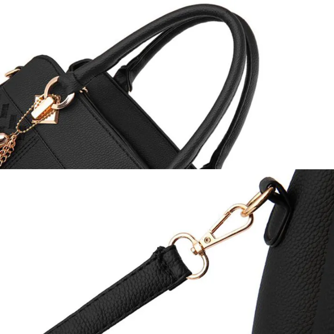 Black shoulder bag detail showing top handle, strap hardware, and textured finish