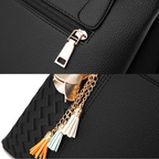Black shoulder bag zipper and tassel chain charm with gold-tone metal accents