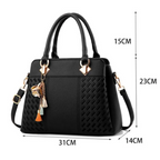 Black women’s shoulder bag with dimensions marked: 31cm wide, 23cm tall