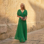 Green off-shoulder pleated maxi dress with draped crossover neckline