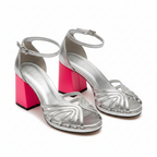 Pair of silver metallic open-toe block heel sandals with ankle strap and layered straps