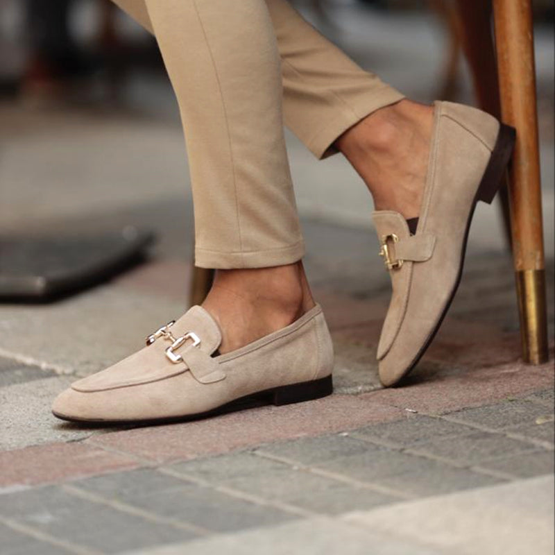 Beige suede slip-on loafers with horsebit detail