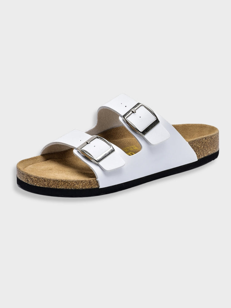 White adjustable buckle slide sandals with two buckle straps and cork footbed