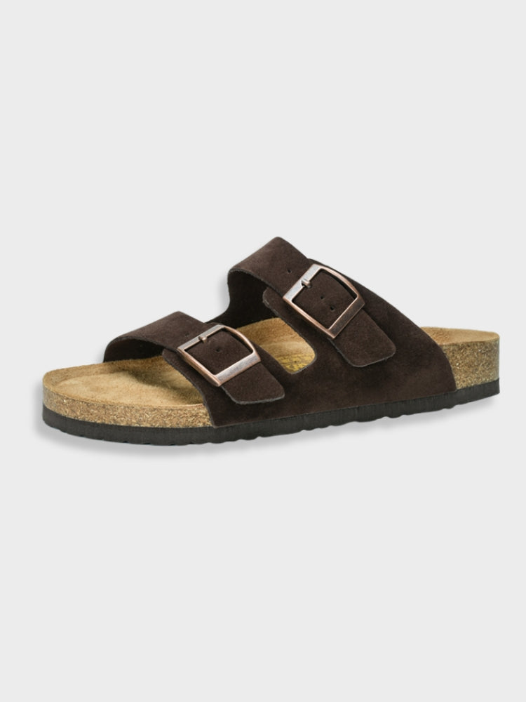Brown adjustable buckle slide sandals with two buckled straps and cork footbed