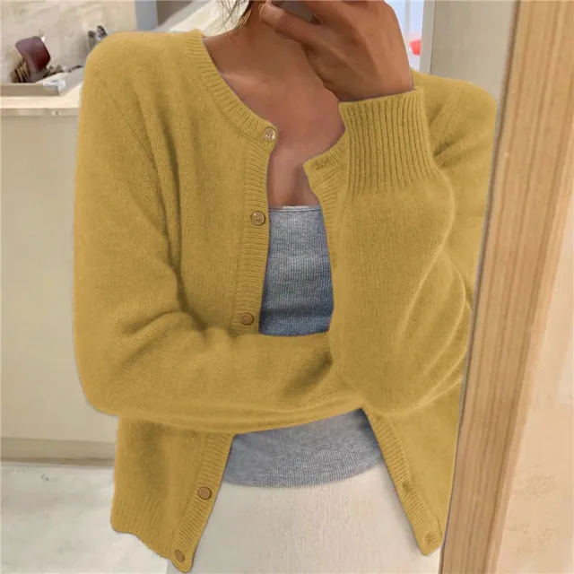 Yellow women's cropped knit cardigan with button front and ribbed round neck.