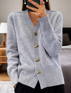 Grey V-neck knit cardigan with gold heart buttons and ribbed hem