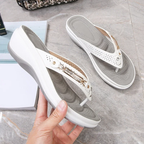 White women's orthopedic thong sandals, side view with gold buckle and perforations