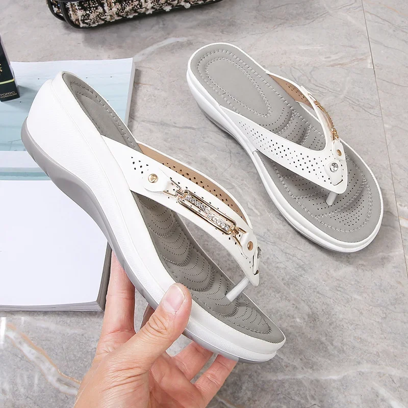 White women's orthopedic thong sandals, side view with gold buckle and perforations