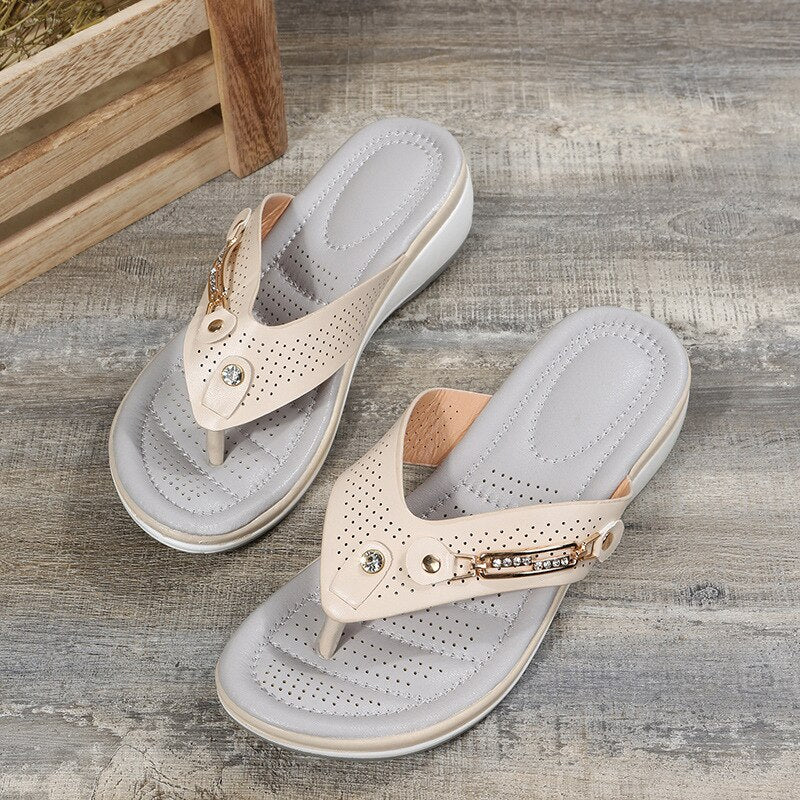 White women's orthopedic thong sandals, two shoes at angle showing side straps