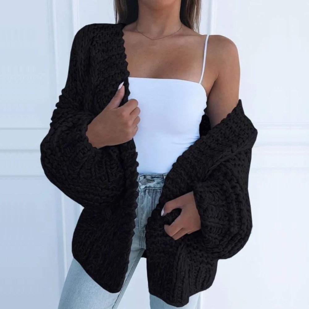 Black chunky knit open cardigan with long sleeves and textured cable-style knit cuffs