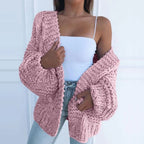 Pink chunky knit open cardigan with long sleeves and textured cable-style knit