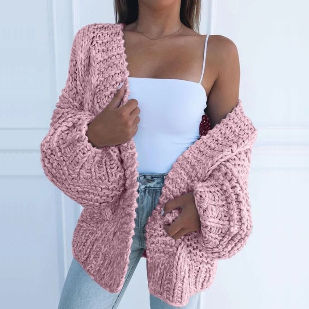 Pink chunky knit open cardigan with long sleeves and textured cable-style knit