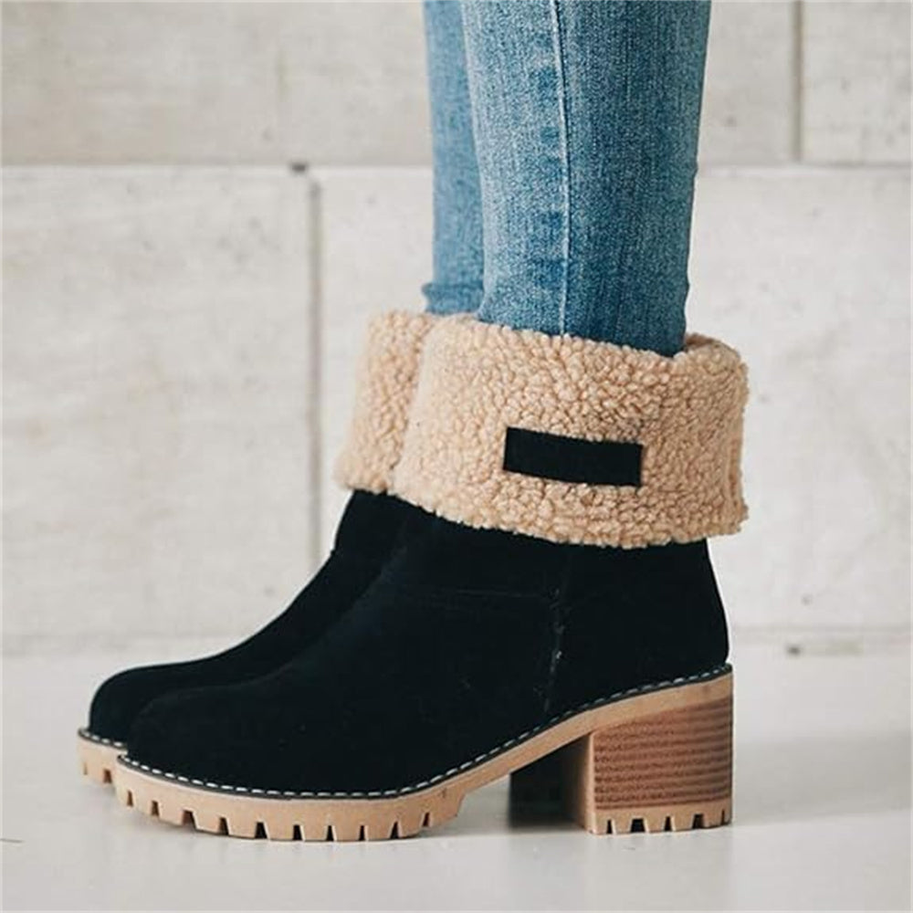 Women’s ankle boots in black suede with cream faux shearling cuff and lug sole heel.