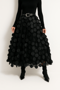 Women’s midi A-line skirt in black with large circular 3D dots and attached belt