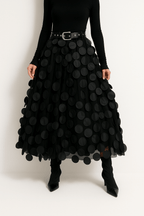 Women’s midi A-line skirt in black with large circular 3D dots and attached belt