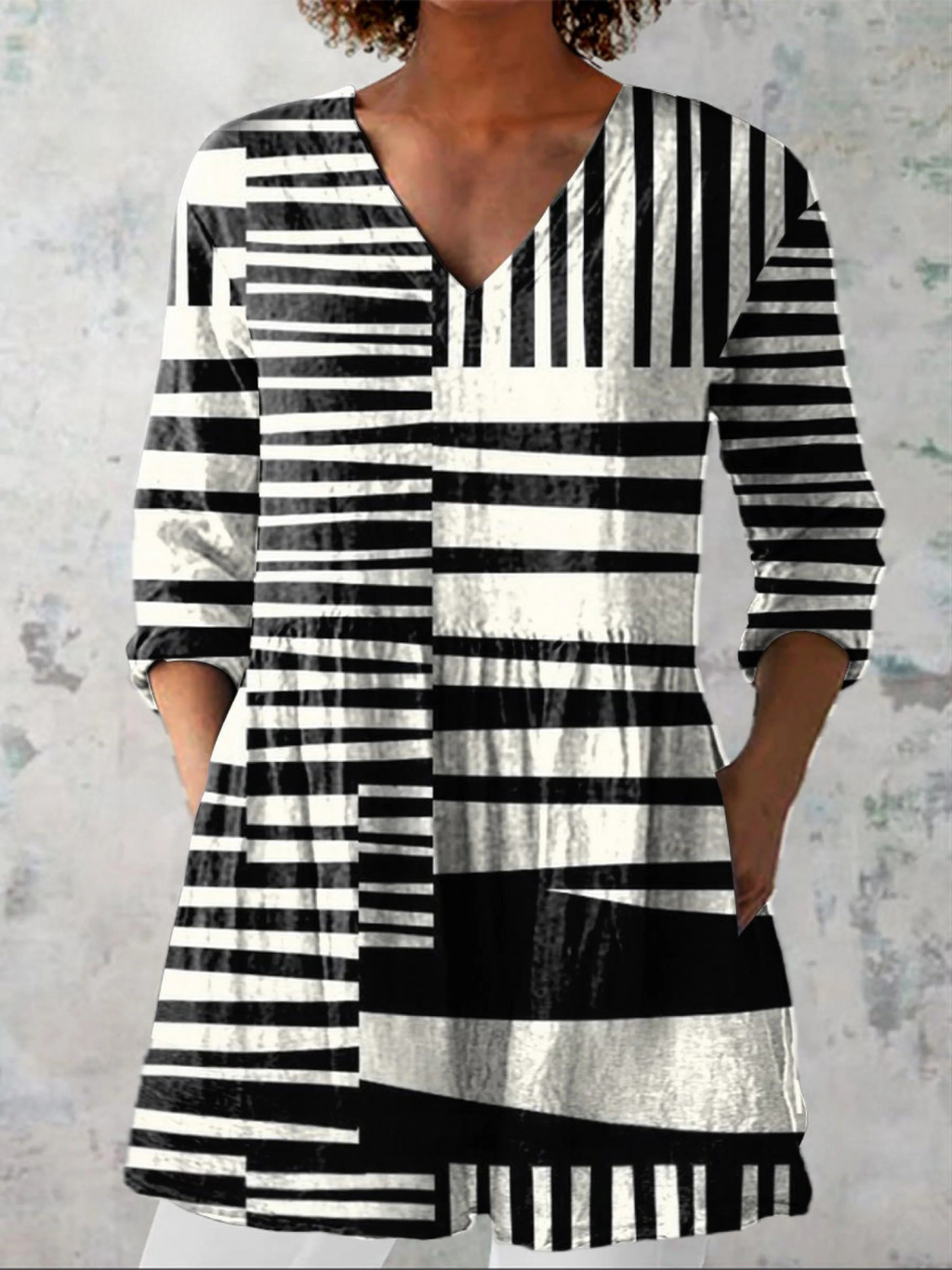 Black-and-white striped V-neck tunic blouse with three-quarter sleeves