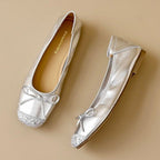 Pair of silver glitter square-toe ballet flats with bow ties and flat sole