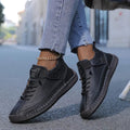 Women's black cushioned leather lace-up sneakers with high-top ankle strap