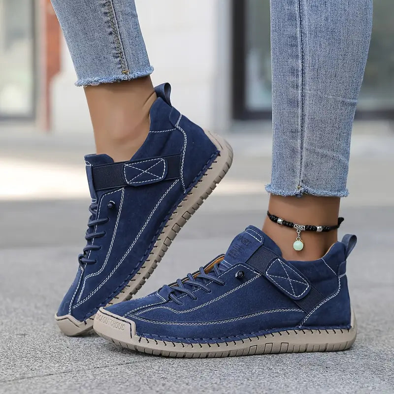 Women's dark blue cushioned leather lace-up sneakers with ankle strap and textured sole