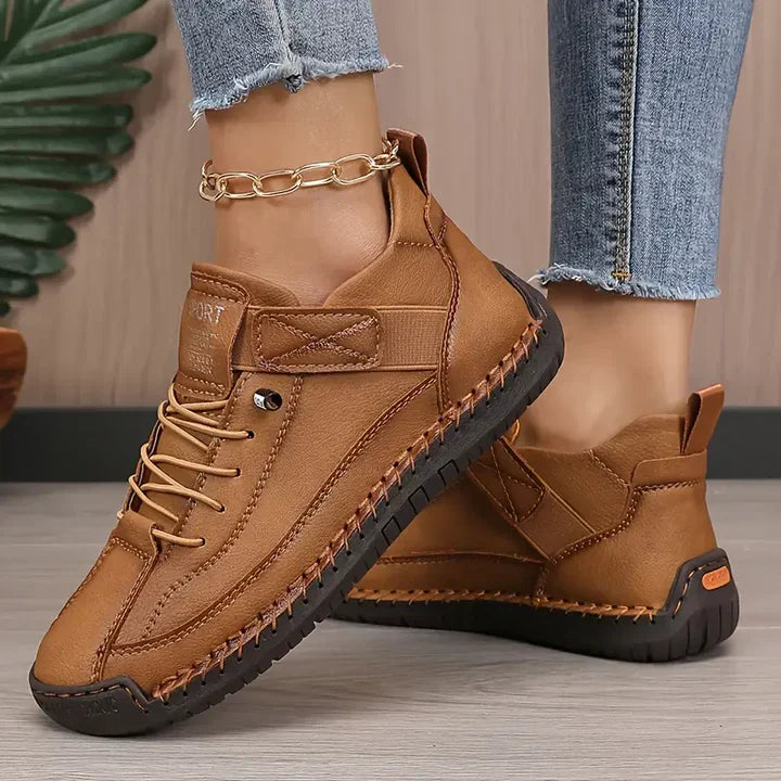 Women's brown cushioned leather lace-up sneakers with ankle strap and thick sole