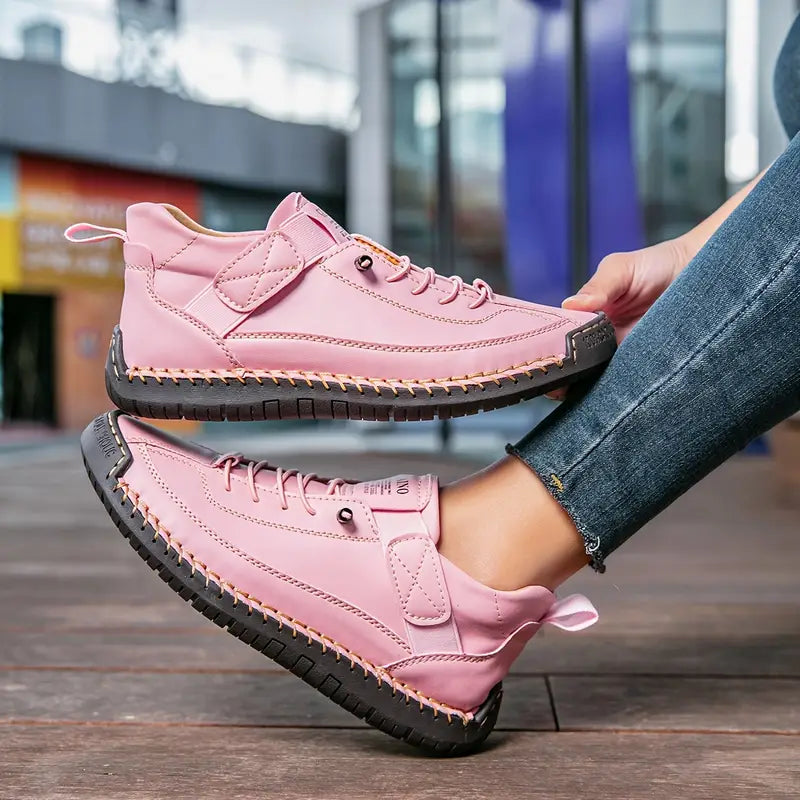 Women's pink cushioned leather lace-up sneakers with high-top design and contrast stitching